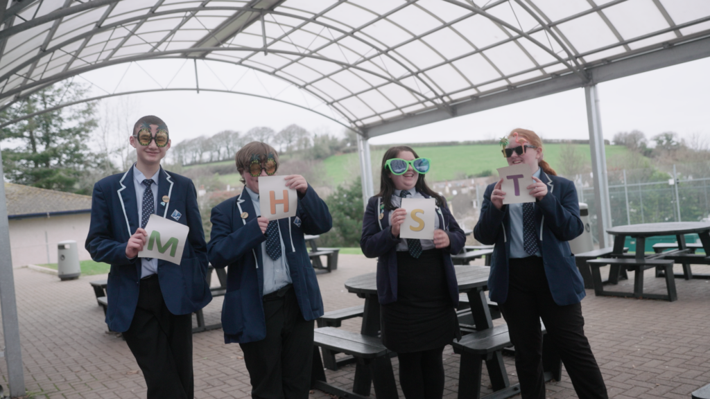 School children holding up letters that spell out MHST