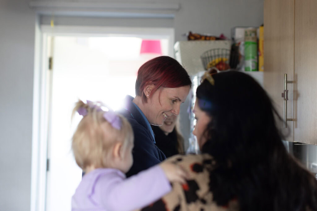 Kim, Community Children's Nurse working with a family during a home visit.